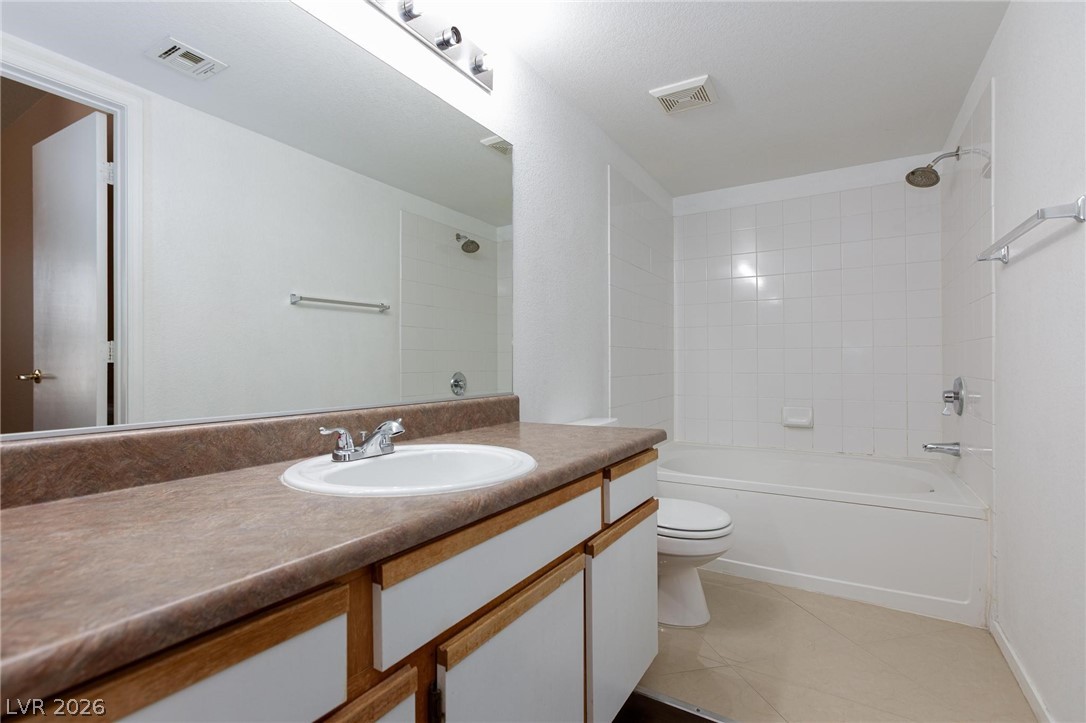 6650 West Warm Springs Road, Unit 2027 Las Vegas, NV 89118 - Photo 23 of 29 This bathroom features a sleek vanity, an inviting bathtub, and classic tile flooring.