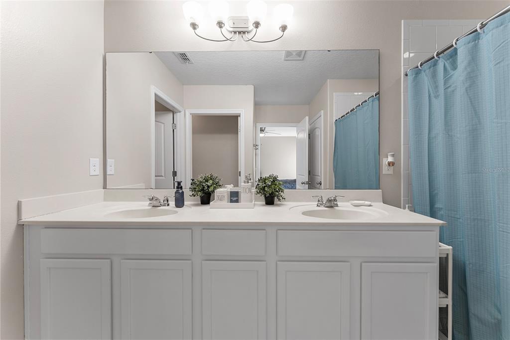3523 Clay Brick Road St. Cloud, FL 34773 - Photo 26 of 62 a bathroom with a sink and a mirror