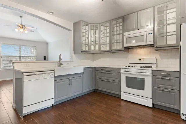 a kitchen with stainless steel appliances white cabinets and a sink