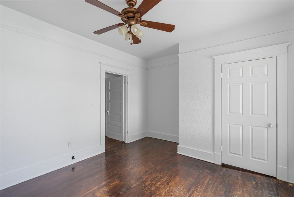 709 East 23rd Street Cisco, TX 76437 - Photo 13 of 17 an empty room with wooden floor closet and ceiling fan