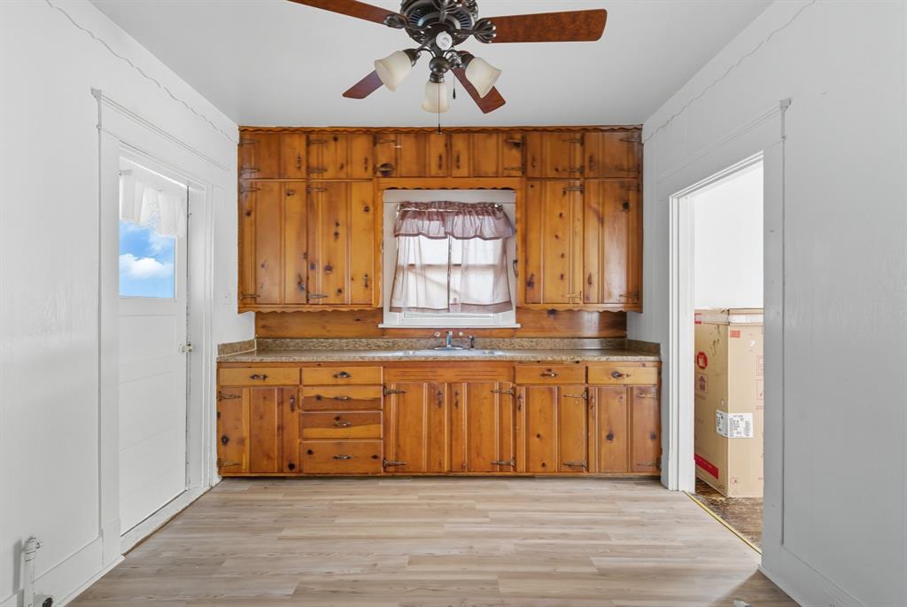 709 East 23rd Street Cisco, TX 76437 - Photo 8 of 17 a bathroom with a granite countertop sink and a mirror