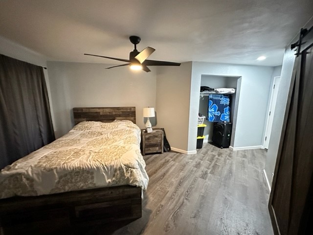 4121 Rice Street, Unit 402 Lihue, HI 96766 - Photo 11 of 20 a bedroom with a bed and a chandelier