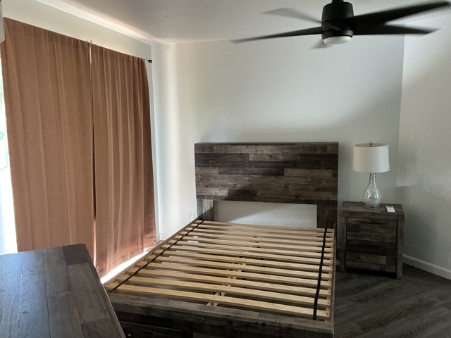 4121 Rice Street, Unit 402 Lihue, HI 96766 - Photo 14 of 20 a bedroom with a bed and wooden floor