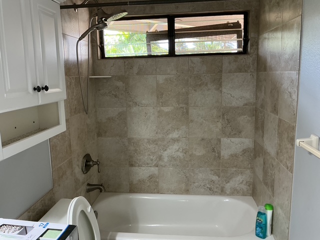 4121 Rice Street, Unit 402 Lihue, HI 96766 - Photo 16 of 20 a bathroom with a tub a toilet and a shower