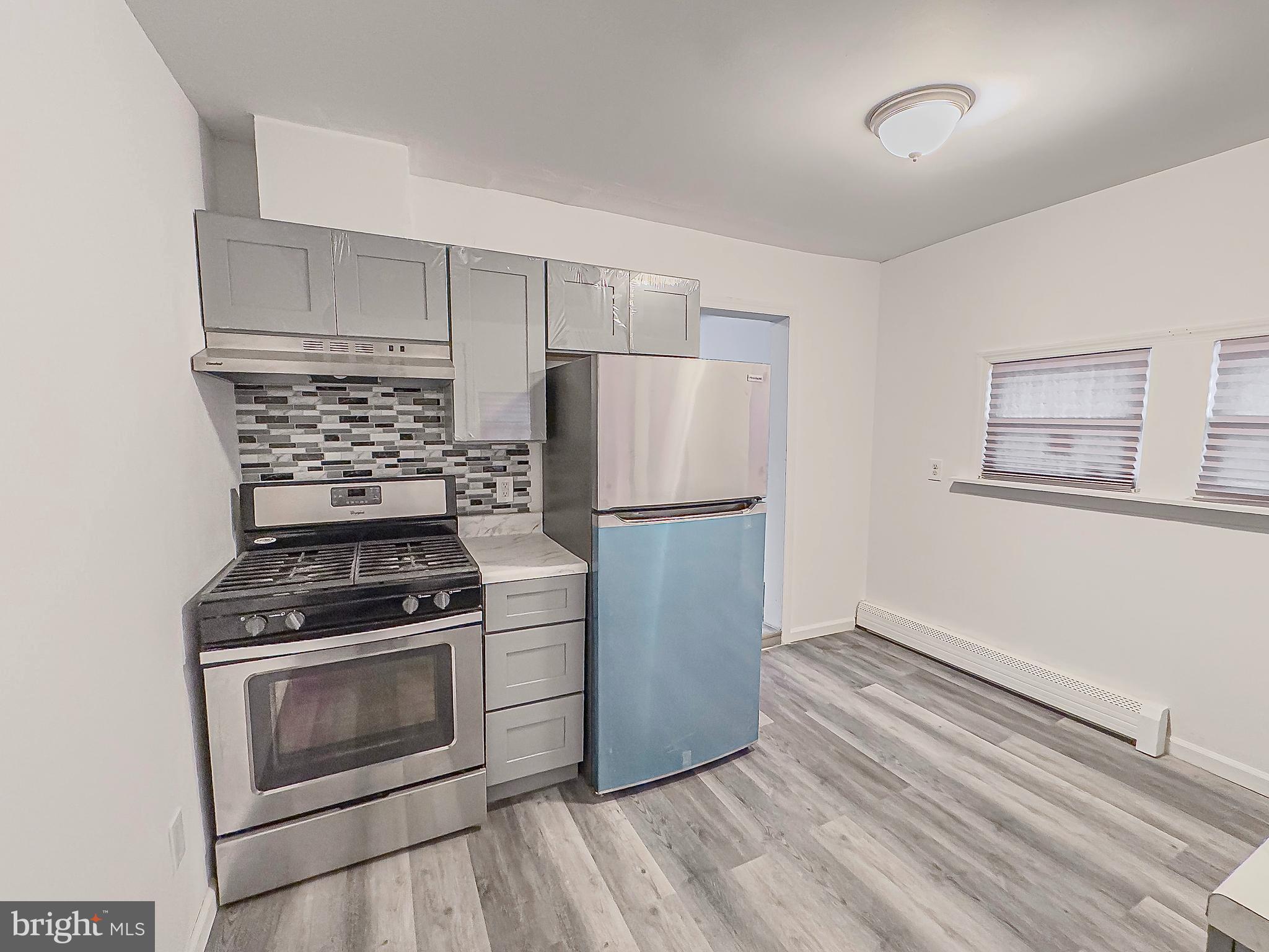 38 Broadway, Unit B Laurel Springs, NJ 08021 - Photo 1 of 9 a kitchen with wooden floors and appliances