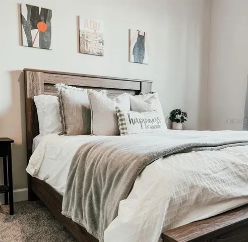 a bedroom with bed and cupboard