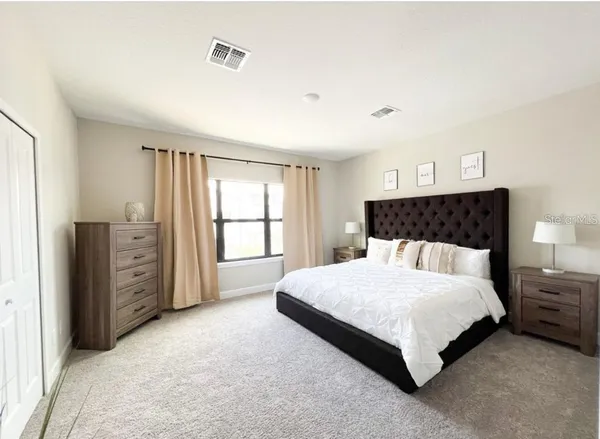 a bedroom with a bed closet and a window