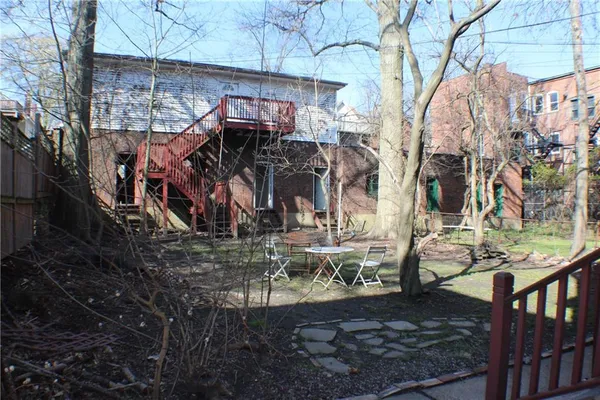 a view of a house with large trees