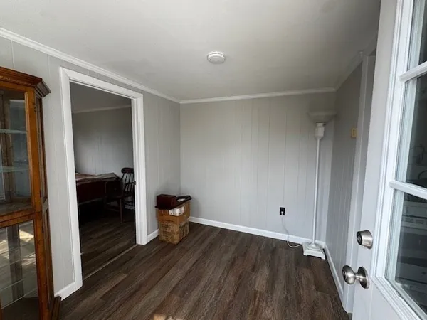 a view of a room that has wooden floor closet and a chair