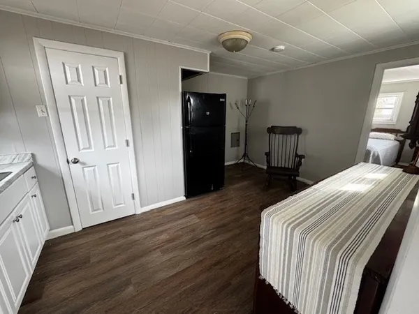 a bedroom with a bed and a mirror on wall