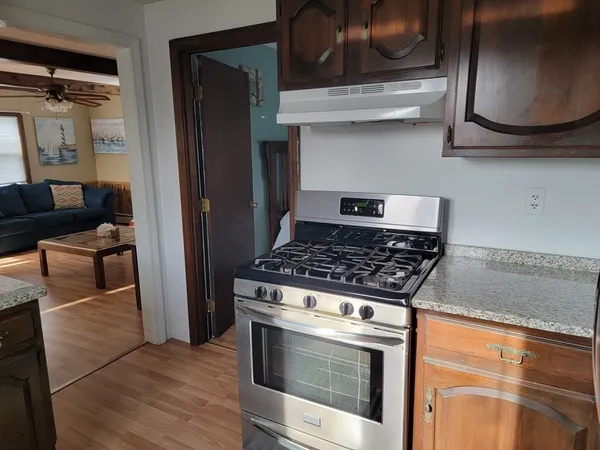 a stove top oven sitting inside of a kitchen
