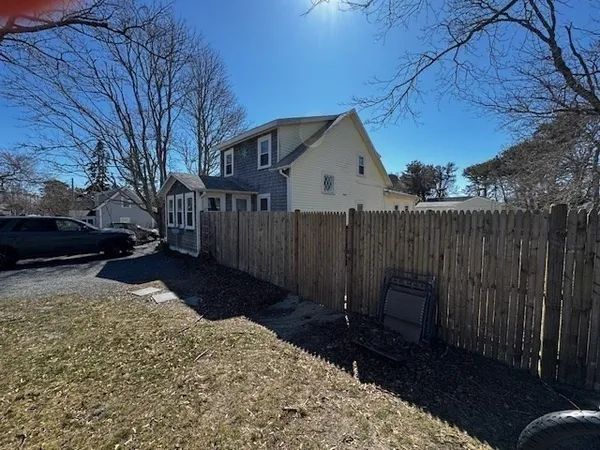 a view of a backyard with wooden fence