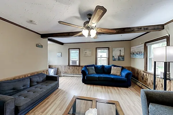 a living room with furniture and a chandelier