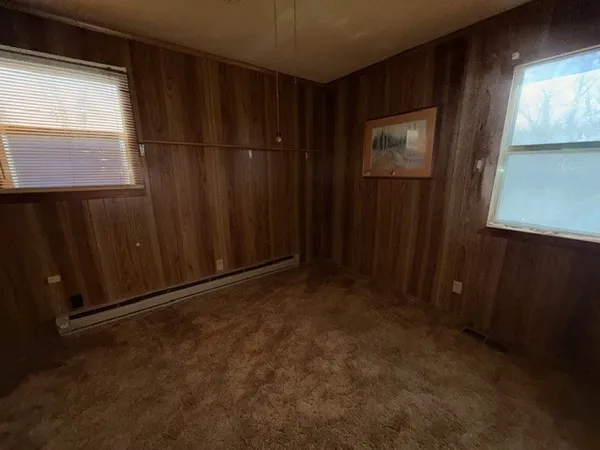 a view of an empty room with wooden door