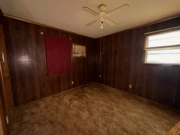 a view of hallway with a ceiling fan and a window