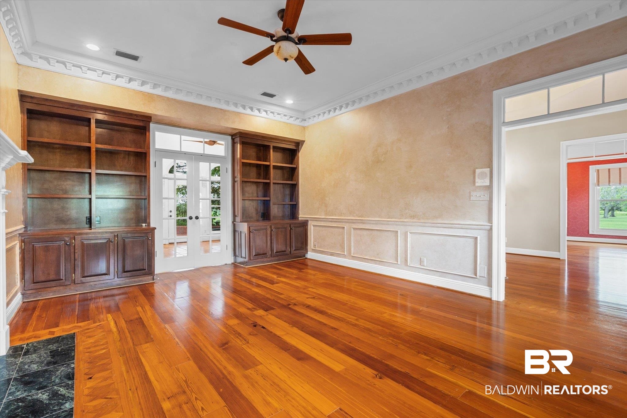 5231 Dawes Road Grand Bay, AL 36541 - Photo 6 of 49 Unfurnished living room featuring ceiling fan, french doors, hardwood / wood-style flooring, built in shelves, and ornamental molding