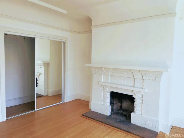 a view of a livingroom with a fireplace and a window