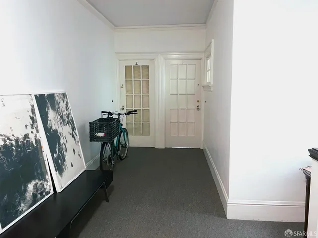 a view of hallway with furniture and a window