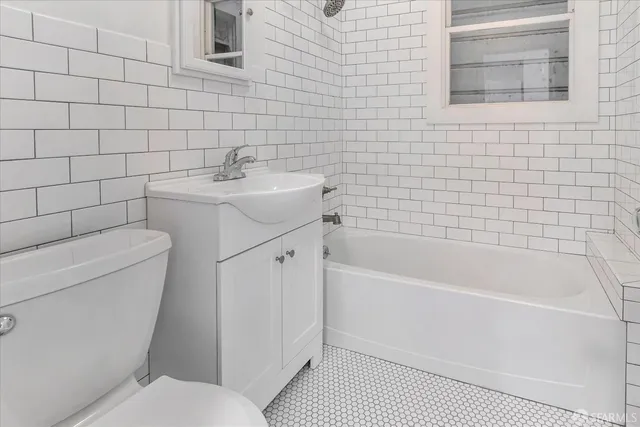 a bathroom with a sink toilet and bathtub