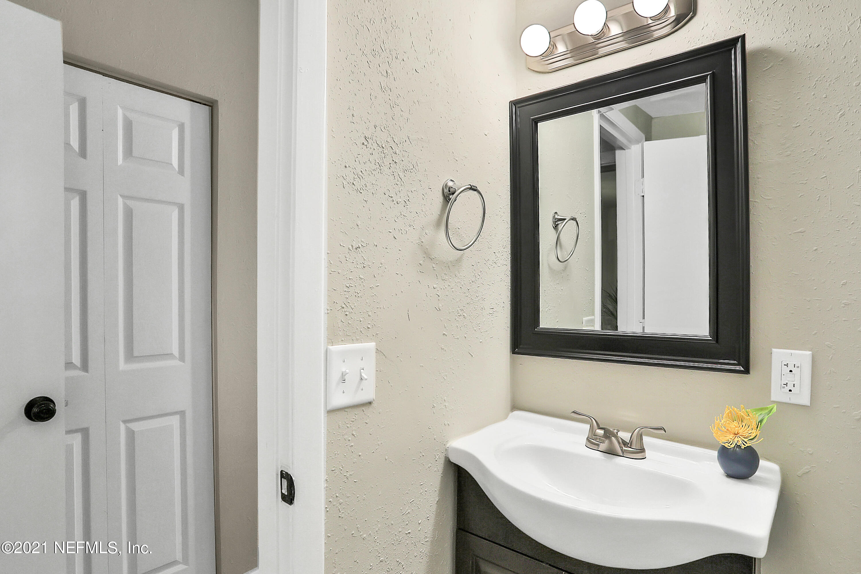 6823 Morgana Road North Jacksonville, FL 32211 - Photo 15 of 23 a bathroom with a sink and a mirror