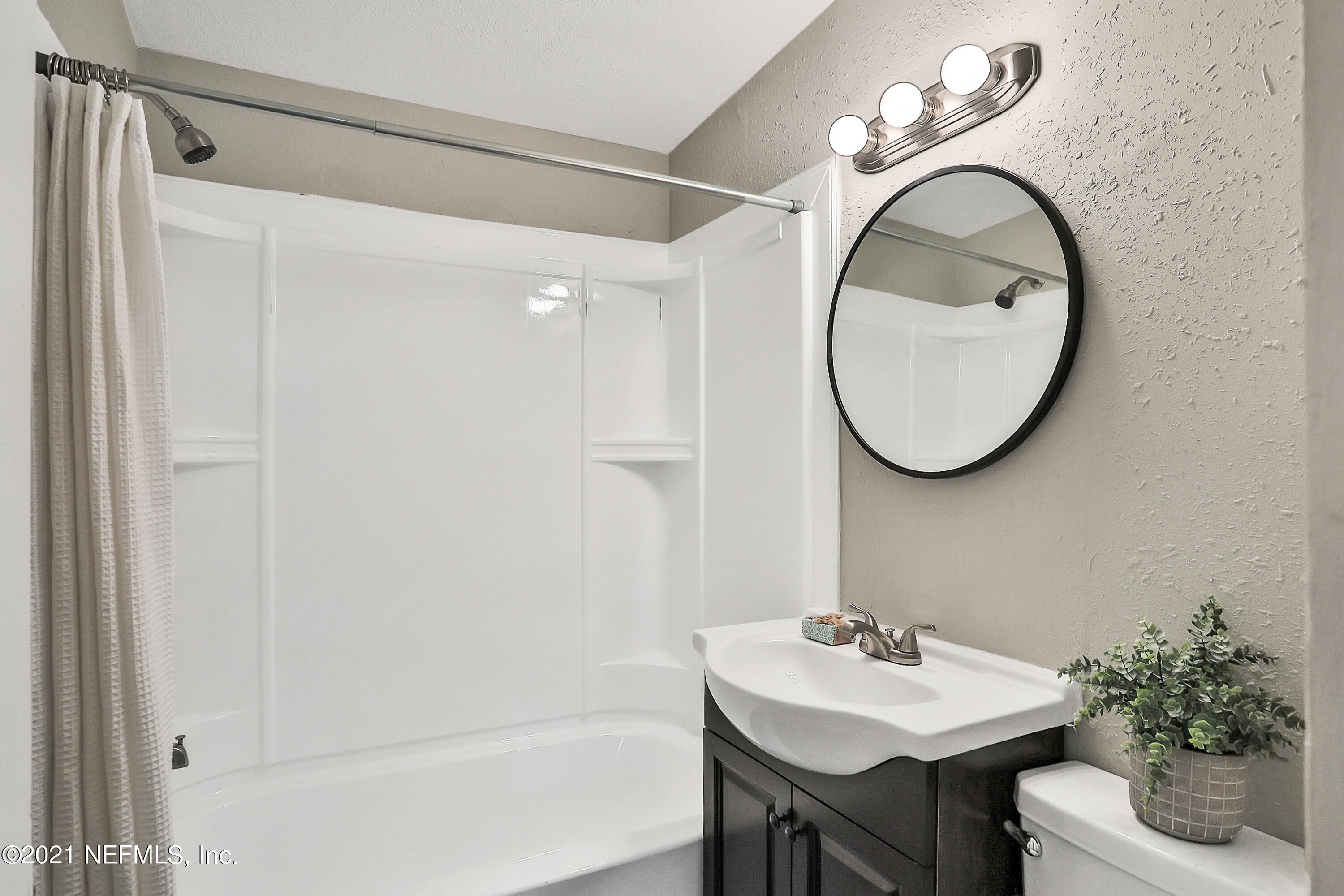 6823 Morgana Road North Jacksonville, FL 32211 - Photo 19 of 23 a bathroom with a sink and a mirror