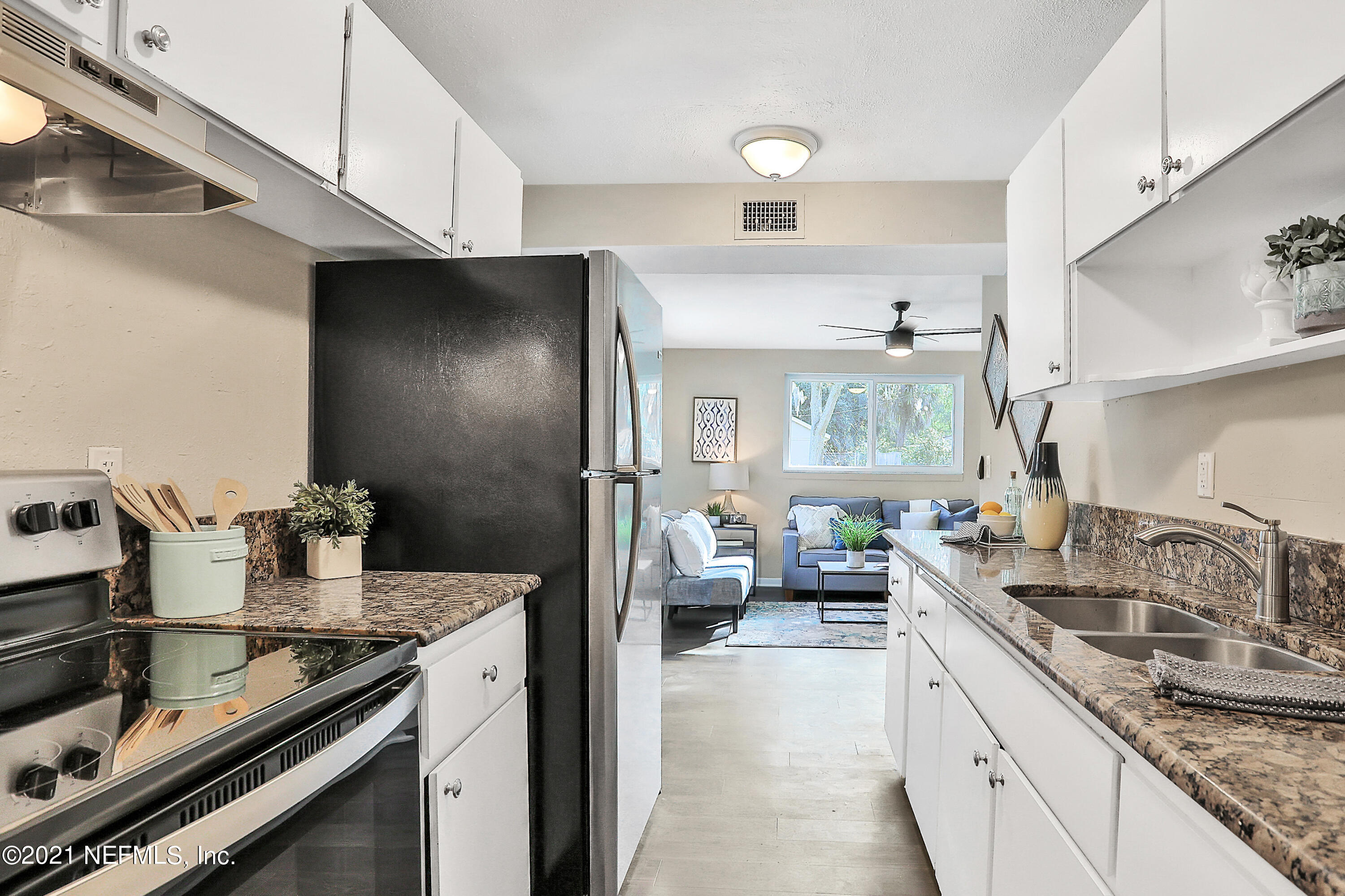 6823 Morgana Road North Jacksonville, FL 32211 - Photo 7 of 23 a kitchen with stainless steel appliances granite countertop a sink stove and refrigerator