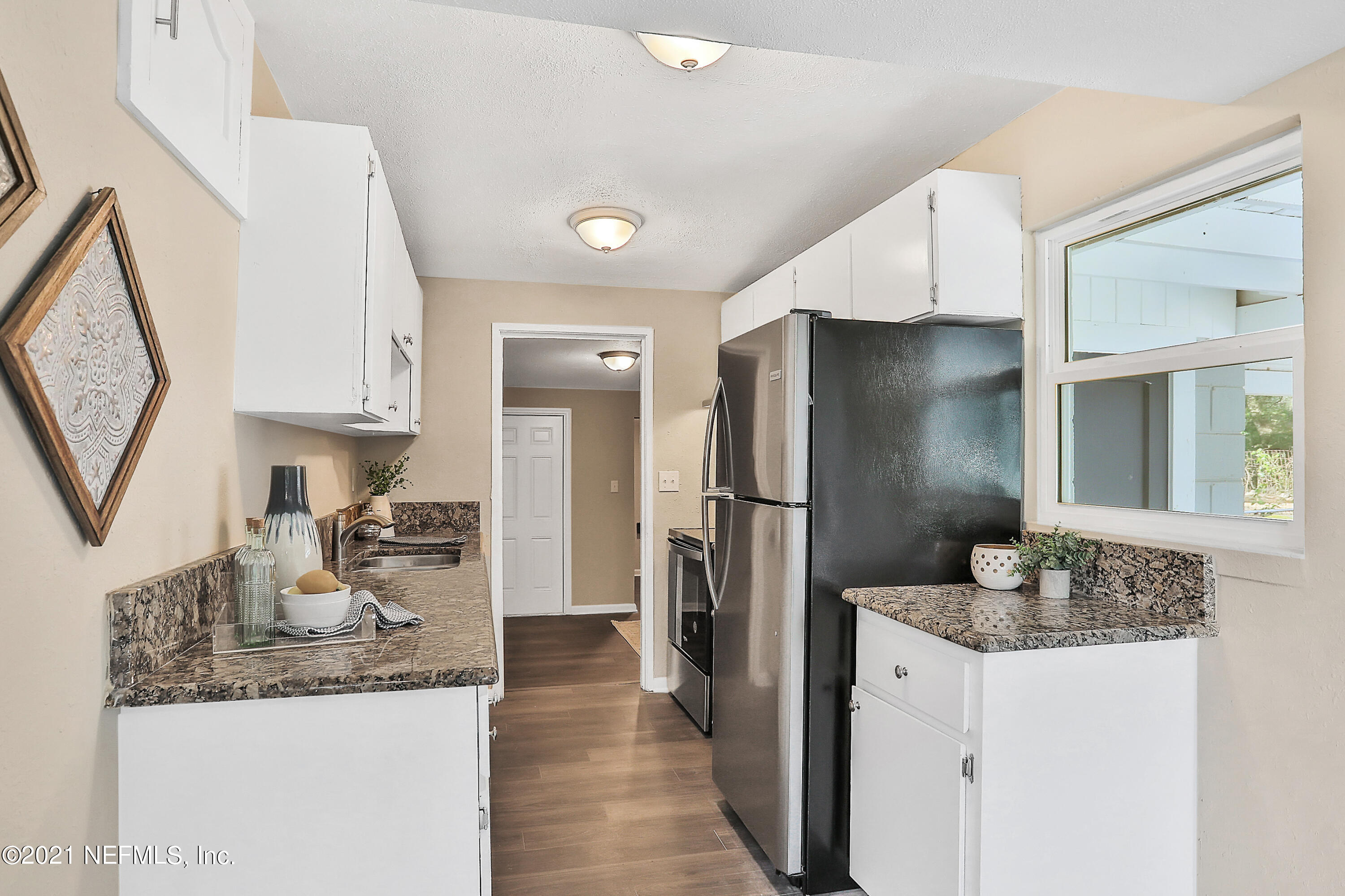 6823 Morgana Road North Jacksonville, FL 32211 - Photo 8 of 23 a kitchen with granite countertop a refrigerator and a sink