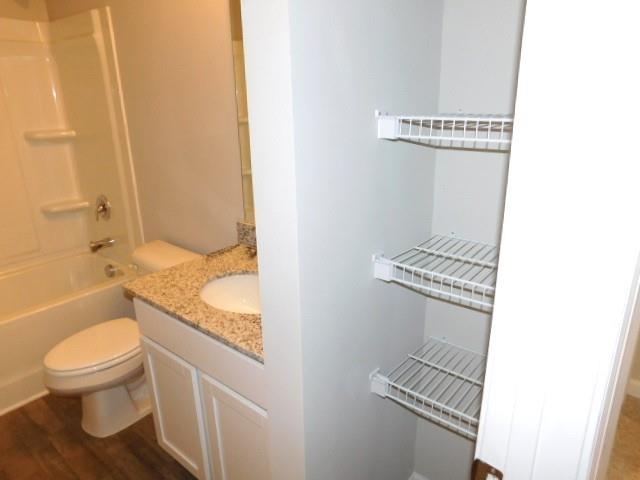 343 Indian Lake Trail Villa Rica, GA 30180 - Photo 20 of 29 a bathroom with a granite countertop toilet and a sink