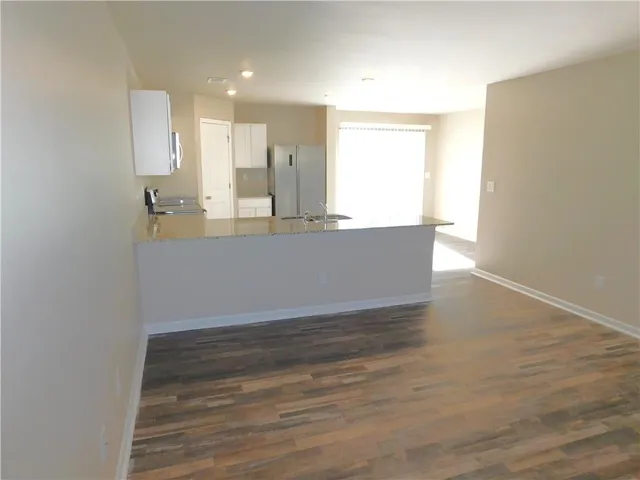 a bathroom with a granite countertop toilet a sink and a bathtub