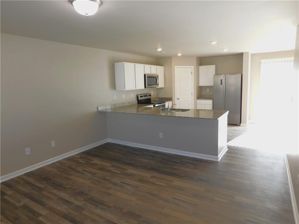 343 Indian Lake Trail Villa Rica, GA 30180 - Photo 5 of 29 a view of kitchen with granite countertop cabinets and refrigerator