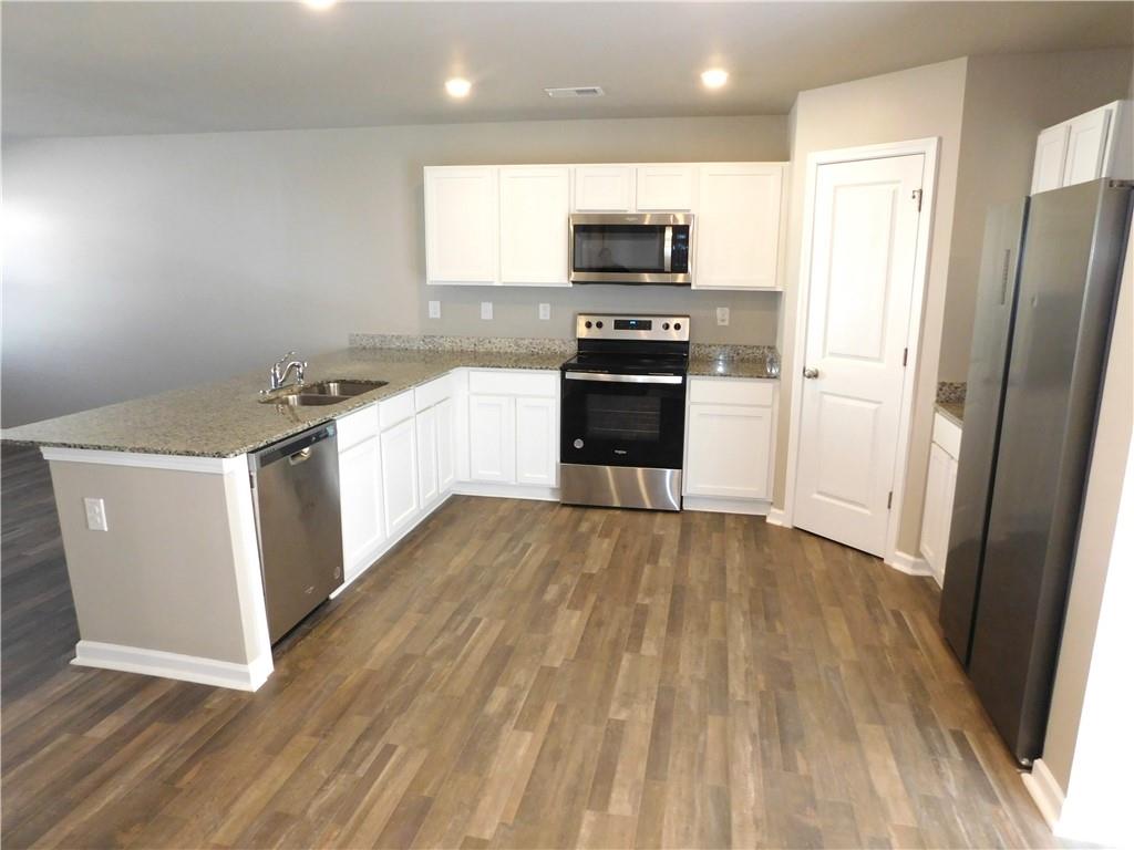 343 Indian Lake Trail Villa Rica, GA 30180 - Photo 7 of 29 a kitchen with stainless steel appliances a refrigerator stove and sink