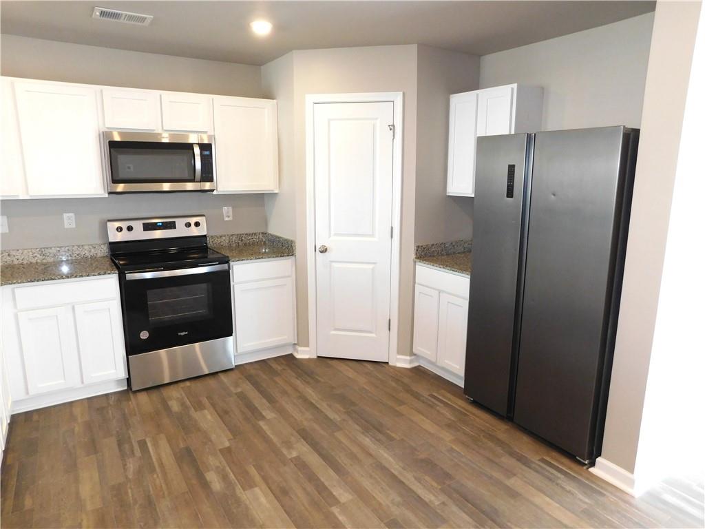 343 Indian Lake Trail Villa Rica, GA 30180 - Photo 8 of 29 a kitchen with a refrigerator and a microwave