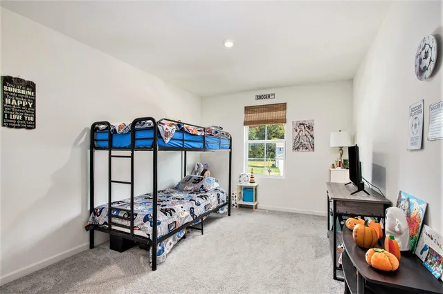 a bedroom with furniture and a window