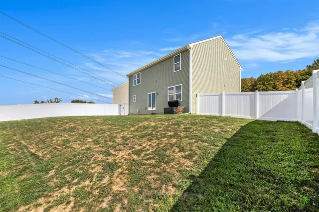 a view of backyard of house with green space