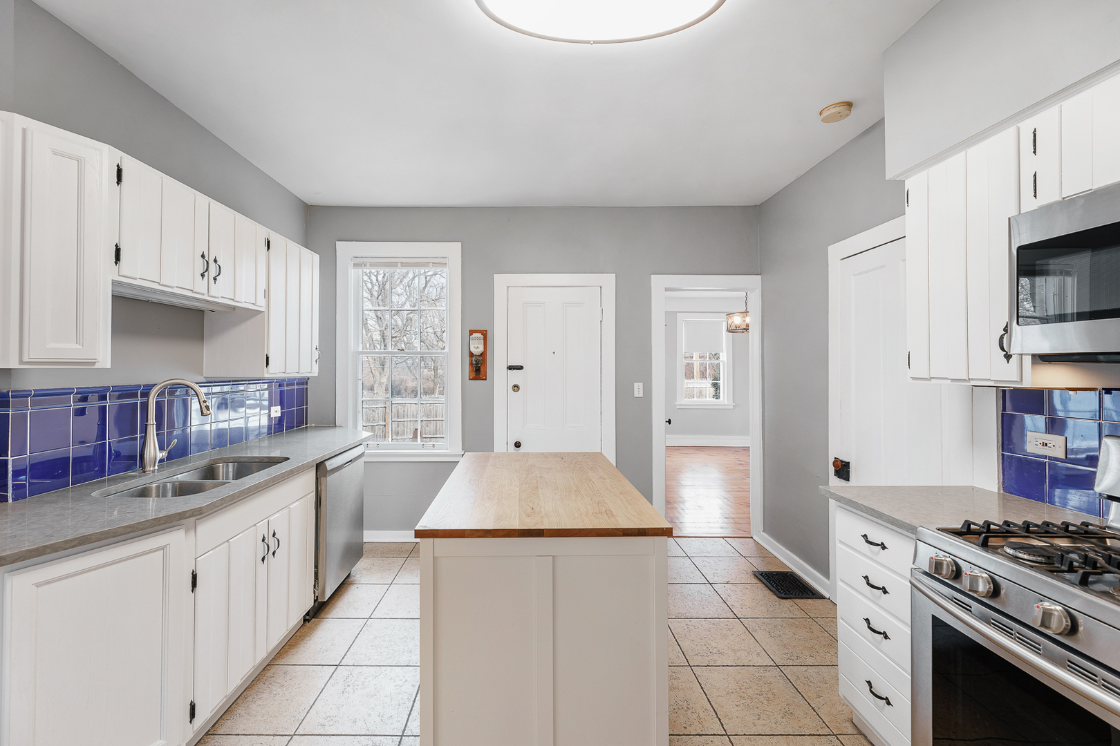 2404 Ridge Avenue Evanston, IL 60201 - Photo 12 of 22 a kitchen with stainless steel appliances a stove a sink and white cabinets