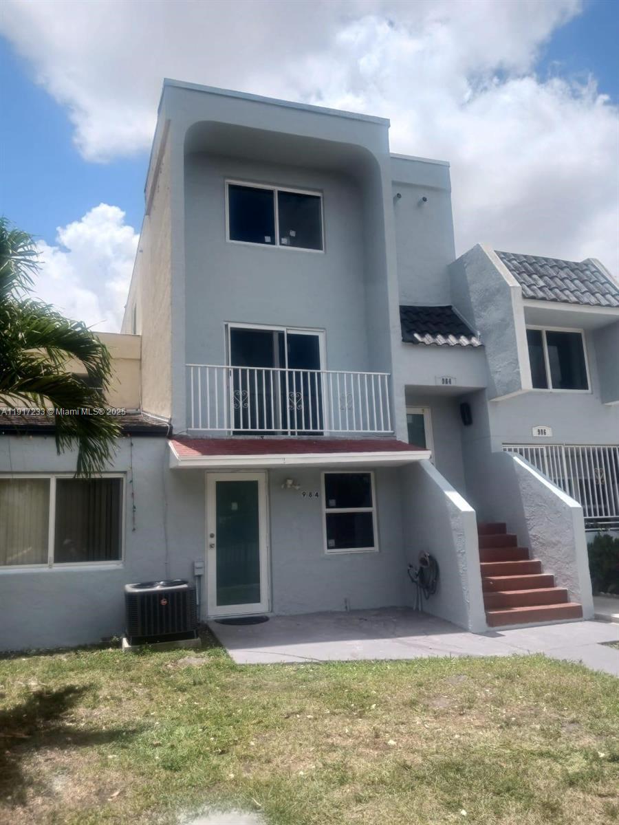 984 West 40th Street, Unit 2 Hialeah, FL 33012 - Photo 1 of 14 a front view of a house with a yard