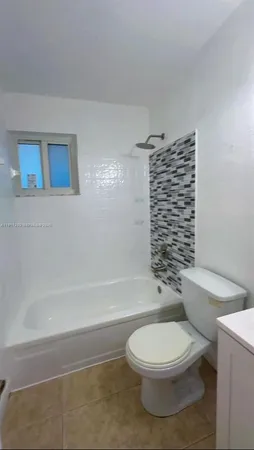 a bathroom with a toilet a sink and shower