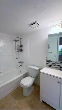 a bathroom with a sink a toilet and a bathtub
