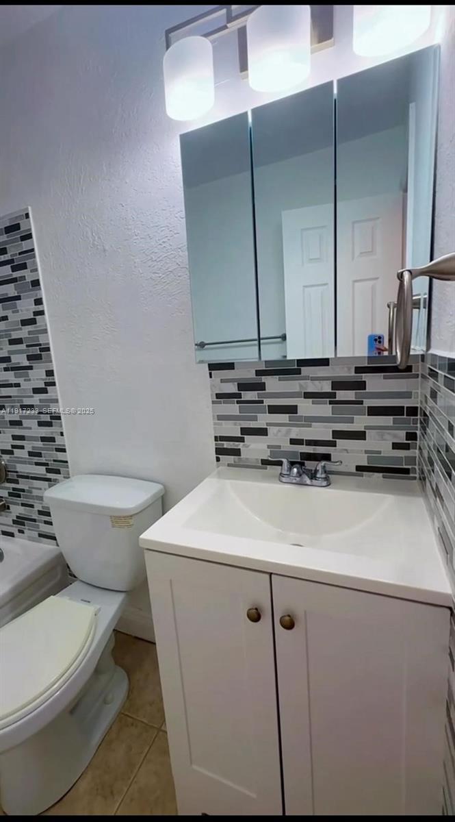984 West 40th Street, Unit 2 Hialeah, FL 33012 - Photo 13 of 14 a bathroom with a sink a toilet and shower