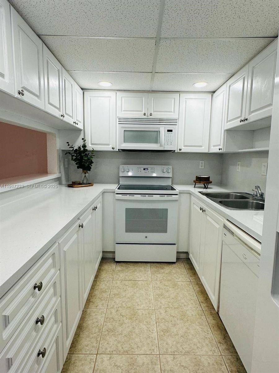 984 West 40th Street, Unit 2 Hialeah, FL 33012 - Photo 3 of 14 a kitchen with cabinets a sink and appliances