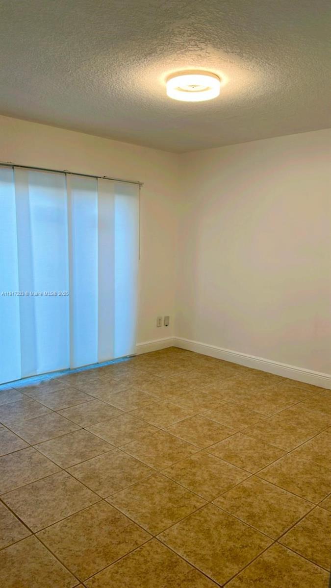 984 West 40th Street, Unit 2 Hialeah, FL 33012 - Photo 4 of 14 a view of an empty room and window