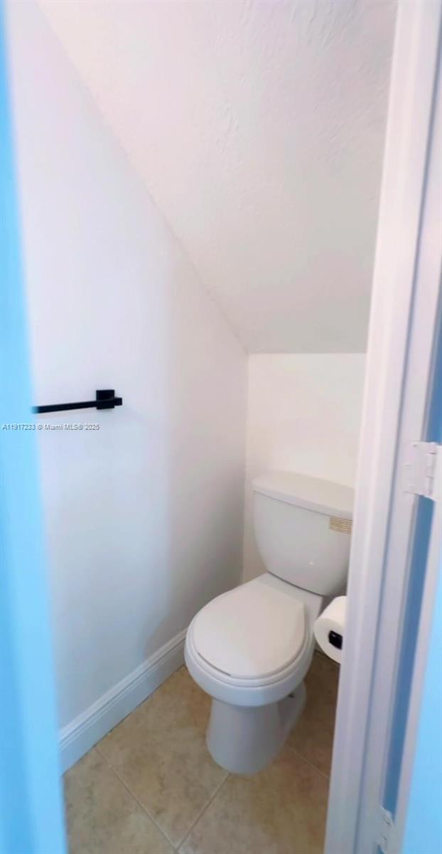 984 West 40th Street, Unit 2 Hialeah, FL 33012 - Photo 6 of 14 a white toilet sitting next to a shower