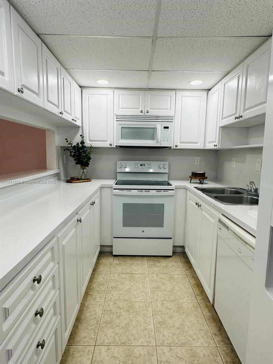 984 West 40th Street, Unit 2 Hialeah, FL 33012 - Photo 8 of 14 a kitchen with cabinets a sink and appliances