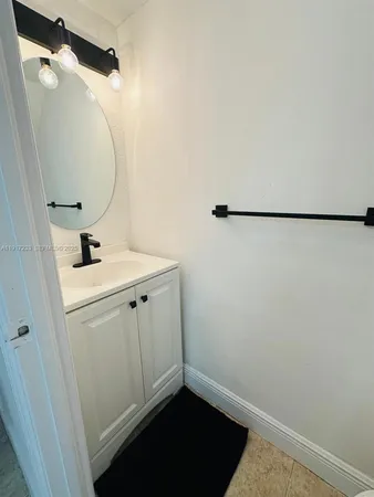 a bathroom with a sink and mirror