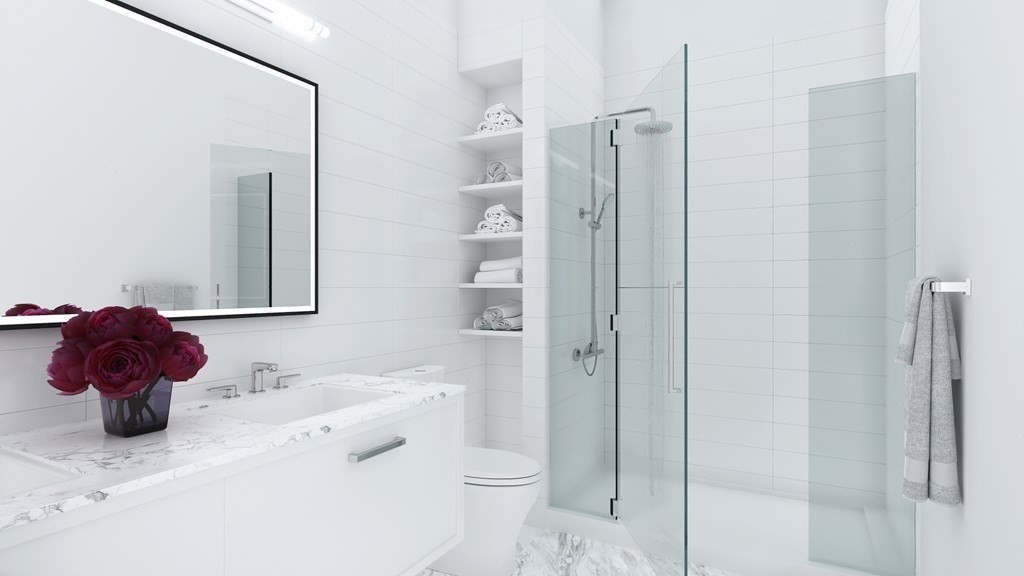 301 Border Street, Unit 612 Boston, MA 02128 - Photo 22 of 32 a bathroom with a sink vanity mirror and toilet