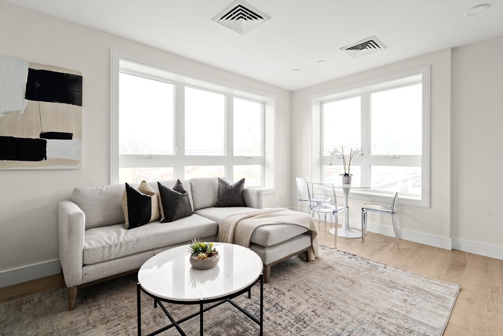 301 Border Street, Unit 612 Boston, MA 02128 - Photo 7 of 32 a living room with furniture and a large window