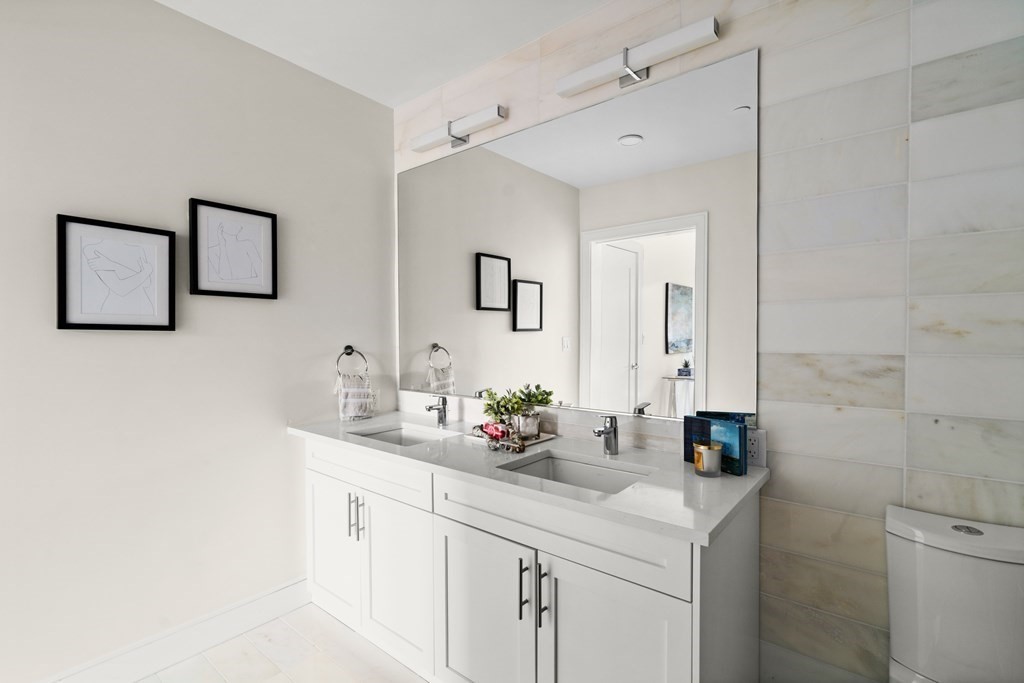301 Border Street, Unit 612 Boston, MA 02128 - Photo 8 of 32 a bathroom with a sink and a mirror