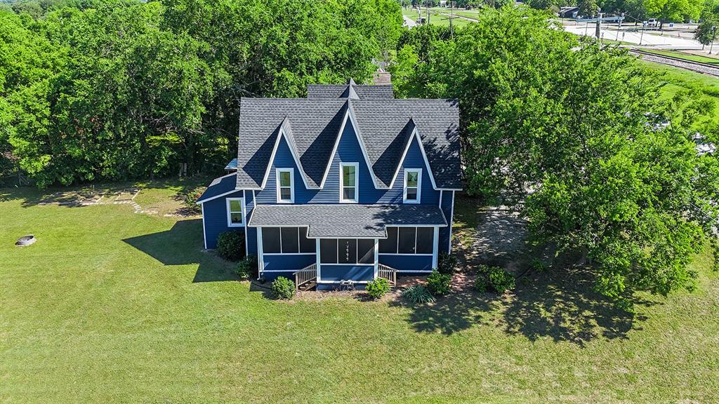 453 East Marshall Street Van Alstyne, TX 75495 - Photo 1 of 30 an aerial view of a house with swimming pool and garden