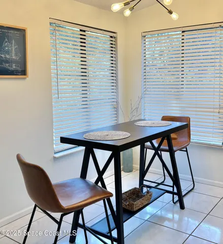 a view of a workspace room with furniture and a window