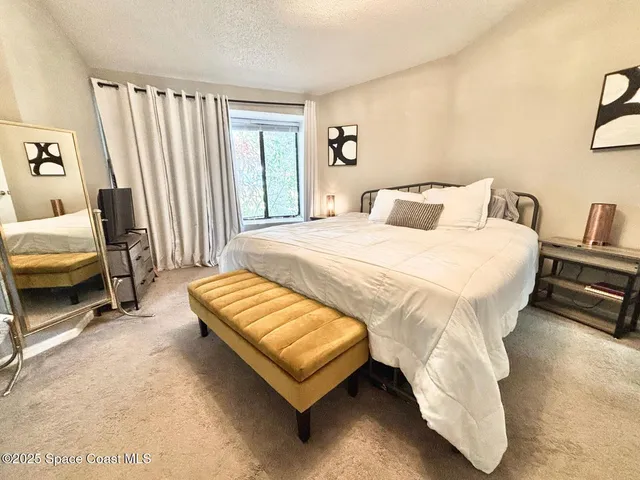 a bedroom with a bed chair and a couch